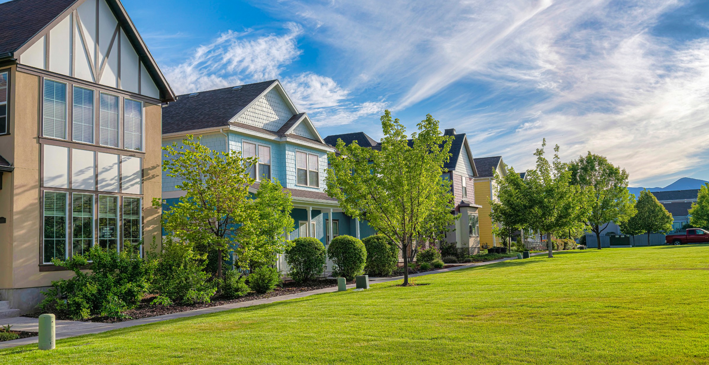 Suburban homes with conventional grass lawns representing the industry being disrupted